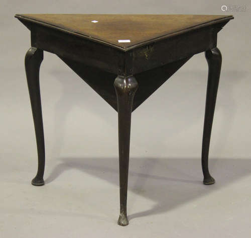 A 19th century mahogany drop-flap corner table, fitted with a hinged lid and well, raised on slender