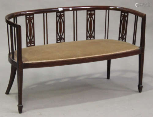 An Edwardian mahogany and line inlaid tub back salon settee with pierced splat supports, on square