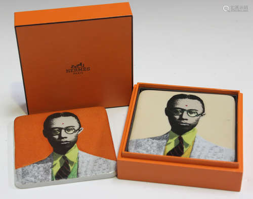 A set of four porcelain coasters by Hermès, Paris, each printed with a portrait of a man, boxed.