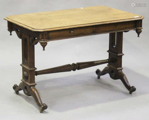 A Victorian Gothic Revival oak side table, the canted rectangular top above two frieze drawers,