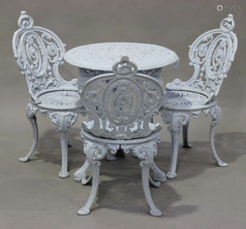 A Victorian blue painted cast iron garden suite of six chairs and two tables with scrolling