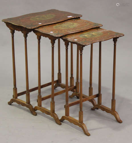 A nest of three Edwardian satinwood and painted occasional tables, each serpentine top painted