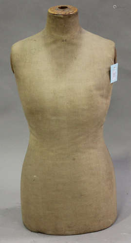 An early 20th century dressmaker's dummy torso with fabric covered body, height 83cm.Buyer’s Premium