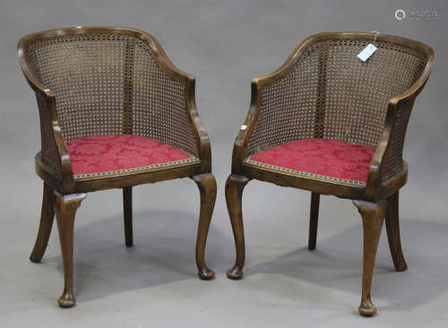 A pair of George V walnut framed bergère armchairs, on cabriole legs, width 60cm.Buyer’s Premium