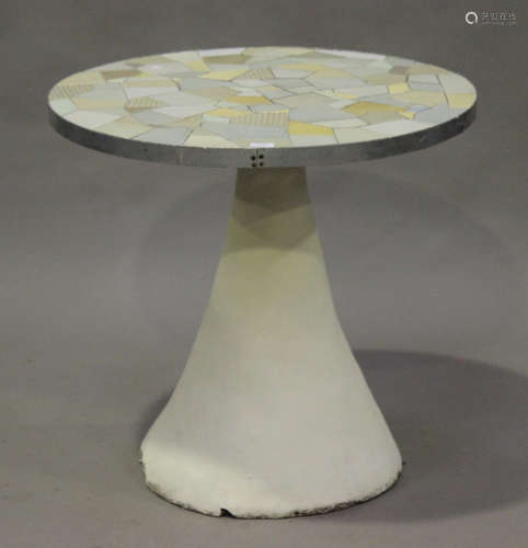 A modern circular garden table, the top inset with blue glazed tiles by Ken Clarke, raised on a