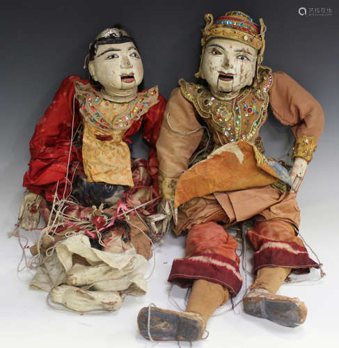 Two early 20th century Indian carved and painted wooden marionettes with moving mouths and hands,