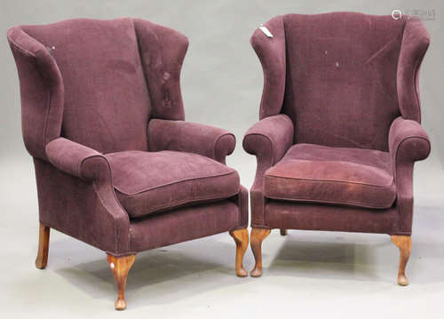 A pair of 20th century George III style wing back armchairs, upholstered in purple velour, raised on