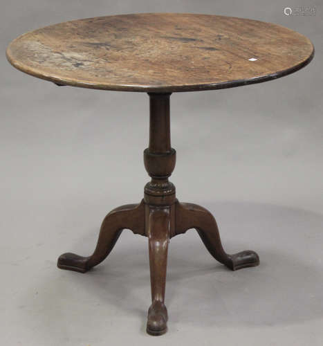 A George III mahogany circular tip-top supper table, on a turned column and tripod cabriole legs