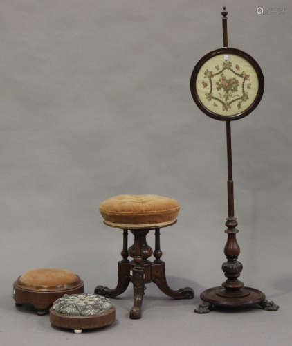 A Victorian walnut revolving piano stool, on carved tripod legs, a Victorian walnut polescreen, a