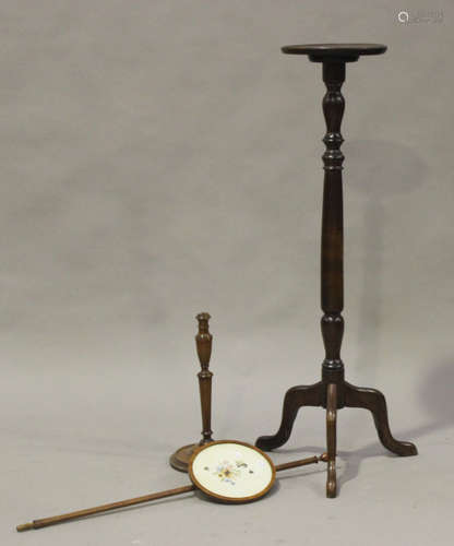 A 20th century oak jardinière stand, the circular top raised on a turned column and tripod legs,