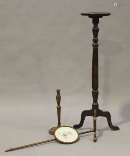 A 20th century oak jardinière stand, the circular top raised on a turned column and tripod legs,