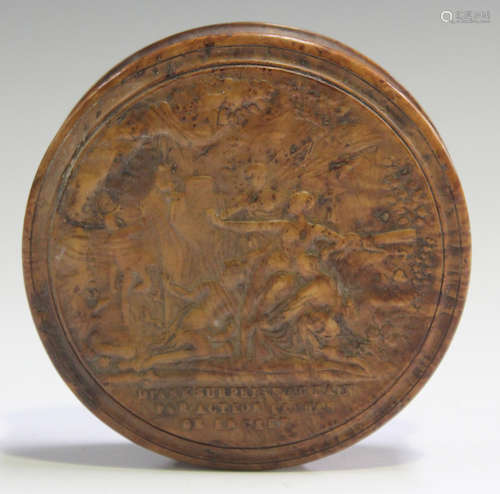 An early 19th century French pressed burr maple circular snuff box, the lid with a titled scene of