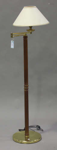 A modern walnut and gilt brass lamp standard by Louis Drimmer, the angle-poise top raised on a