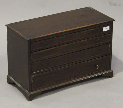 A George III mahogany table-top chest of four graduated long drawers, all with crossbanded