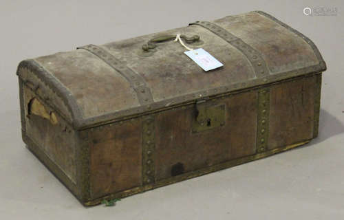 A 19th century brown leather and brass mounted dome topped box with brass handle and papered