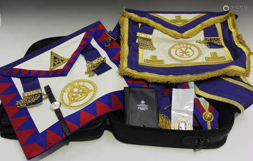 A collection of Masonic regalia, including medals, books, a watch and aprons.Buyer’s Premium 29.