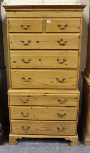 A modern pine chest-on-chest, fitted with two short and six long drawers, on bracket feet, height