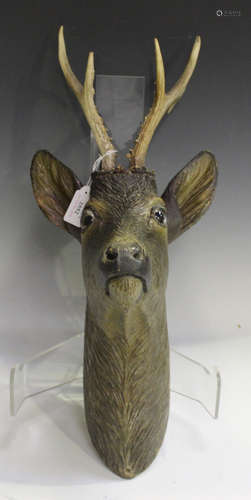 An early/mid-20th century carved softwood model of an ibex head with inset glass eyes and attached