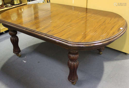 A 20th century William IV style mahogany extending dining table with two extra leaves, raised on