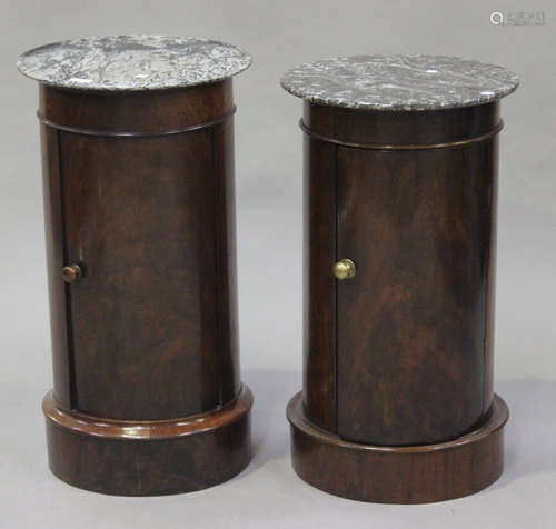 A matched pair of Victorian mahogany cylindrical pot cupboards with grey marble tops above single