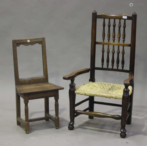 A 17th century oak framed chair, the solid seat raised on turned and block legs united by
