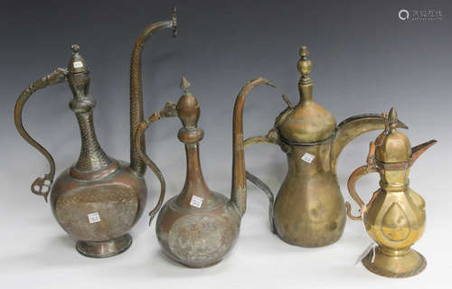 A Middle Eastern copper coffee pot with engraved decoration, height 33.5cm, another similar copper