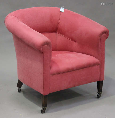 An early 20th century tub back armchair, upholstered in pink cotton, on square tapering legs, height