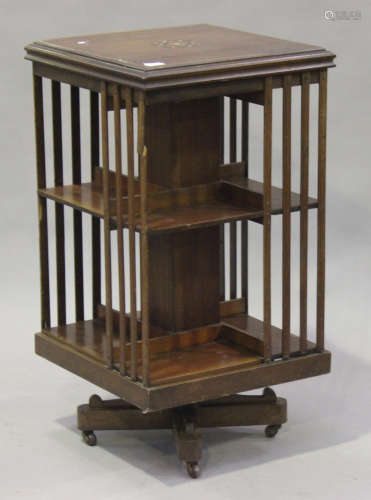 An Edwardian mahogany revolving bookcase with inlaid decoration, on an 'X' shaped support, height
