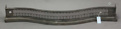 A 20th century George III style steel fender of pierced serpentine form, width 110cm.Buyer’s Premium