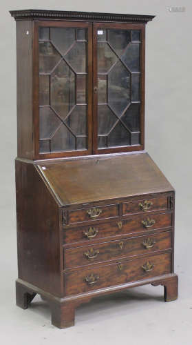 A George III mahogany bureau bookcase, the dentil moulded pediment above a pair of astragal glazed