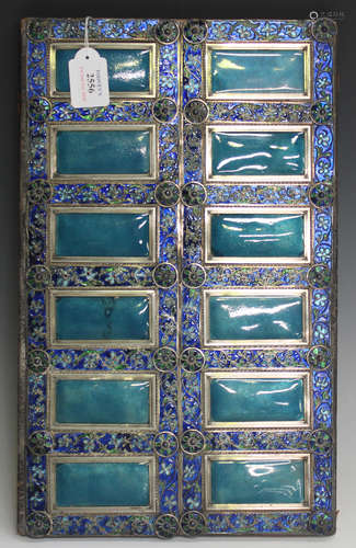 A 19th century white metal and enamelled rectangular panel, worked with twelve turquoise enamel