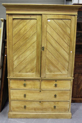 A Victorian ash linen press, the moulded pediment above a pair of panelled doors revealing sliding