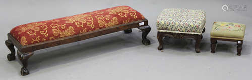 A George V walnut footstool, width 103cm, together with two smaller footstools.Buyer’s Premium 29.4%