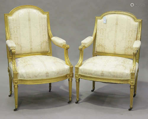 A pair of 20th century Louis XVI style giltwood and gesso fauteuil armchairs with carved decoration,