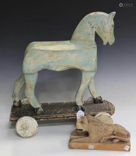 A 20th century carved and painted push-along model of a horse, length 46cm, together with a folk art