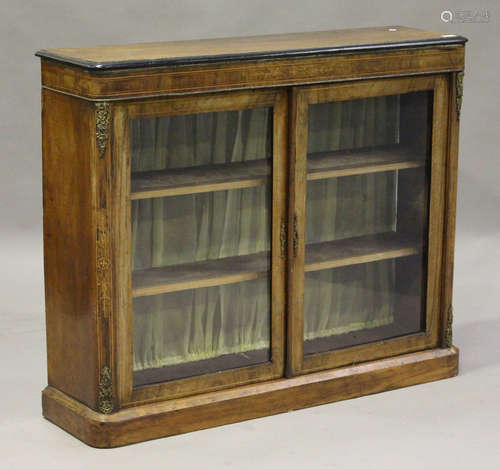 A Victorian walnut and ebonized pier cabinet with inlaid decoration and gilt metal mounts, fitted