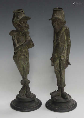 A pair of late 19th century French patinated spelter figural candlesticks in the form of humorous