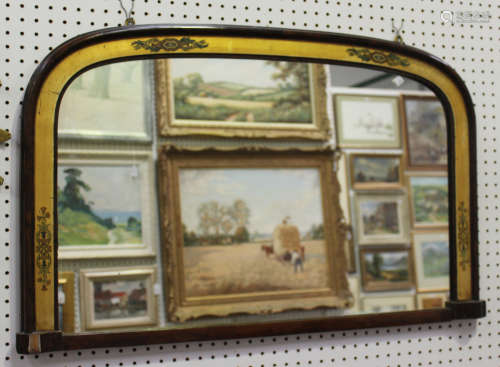 A late Victorian faux walnut overmantel mirror with a gilded and transfer decorated inner border,
