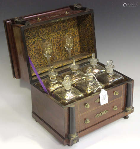 A 19th century Continental mahogany decanter box in the form of a commode, the hinged lid