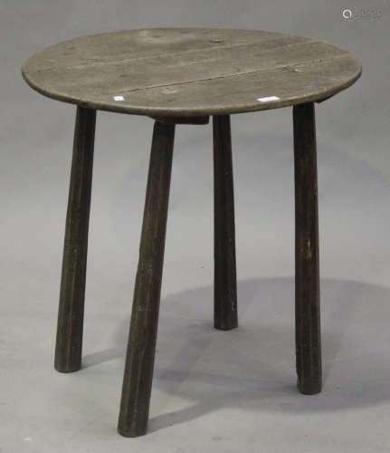 A 19th century provincial oak circular occasional table, raised on chamfered block legs, height