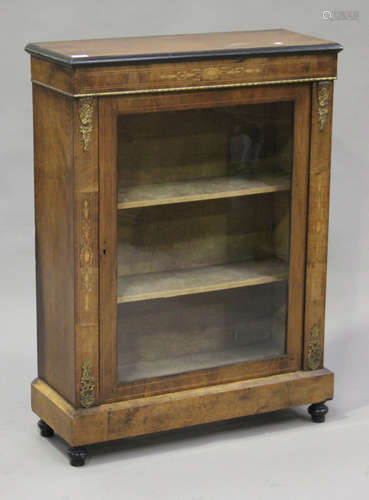 A Victorian walnut and inlaid pier cabinet with gilt metal mounts, the moulded top above a glazed