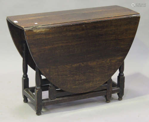 An 18th century oak oval gateleg table, fitted with a drawer, on turned and block legs, height 68cm,