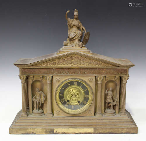 A late 19th century brass cased mantel clock with eight day movement striking on a gong, the black