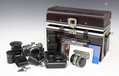 A collection of Olympus cameras and accessories, including an OM-1 camera body, OM10 camera body,