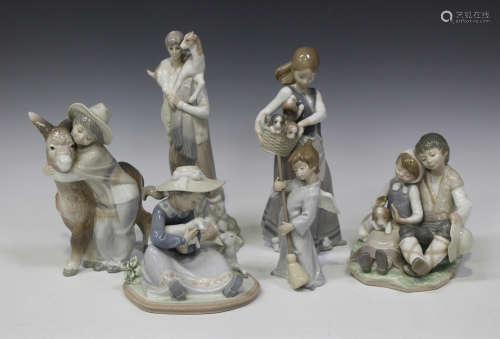 A collection of fourteen Lladro porcelain figures, including Platero and Marcelino, No. 1181, Girl