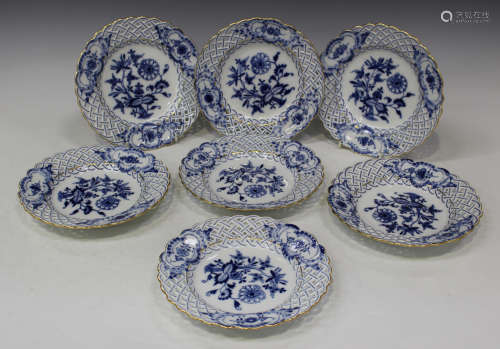 A set of seven Meissen blue and white porcelain plates, 20th century, each decorated with the