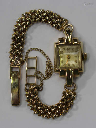 A Record 9ct gold shaped rectangular cased lady's wristwatch with a signed jewelled movement, the