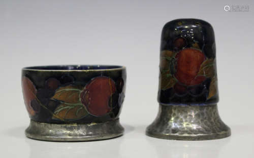 A Moorcroft pottery and Tudric pewter pepperette and matching salt, circa 1913-25, each decorated