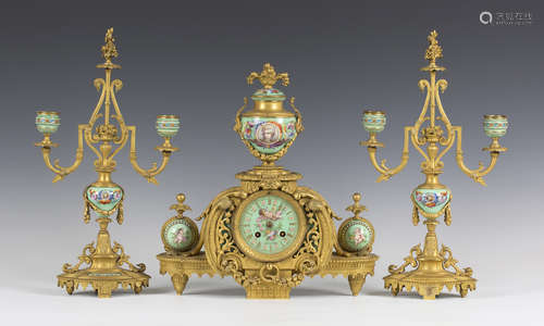 A late 19th century French ormolu and jewelled porcelain mantel clock garniture, the clock with