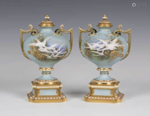 A pair of Royal Worcester porcelain two-handled vases and covers, circa 1896 and 1897, the bulbous